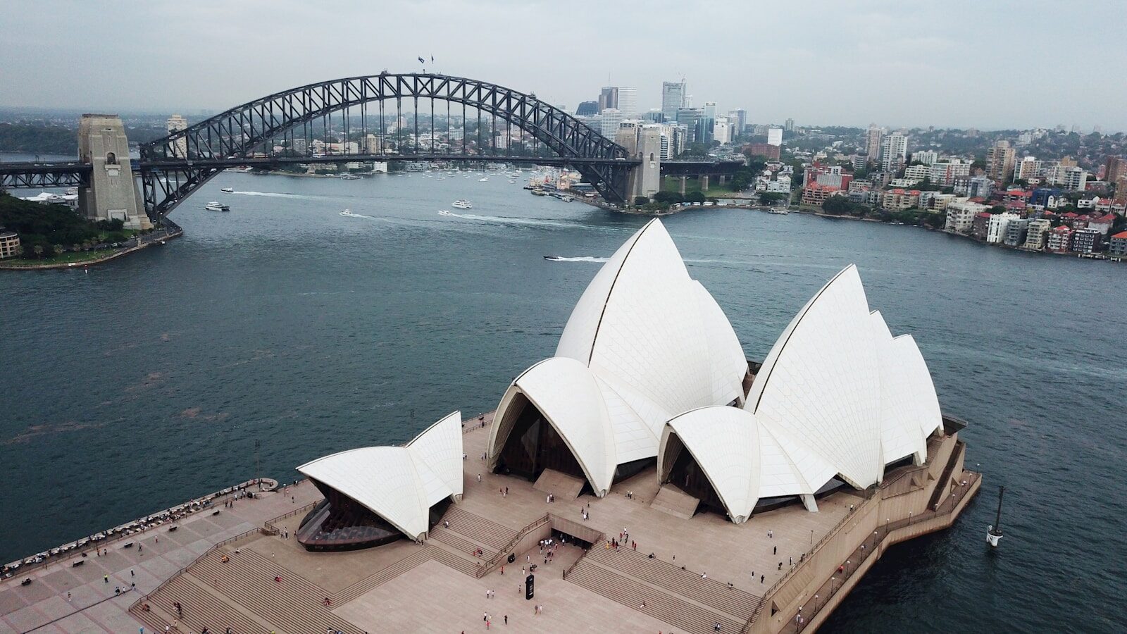 a large building with a bridge in the background