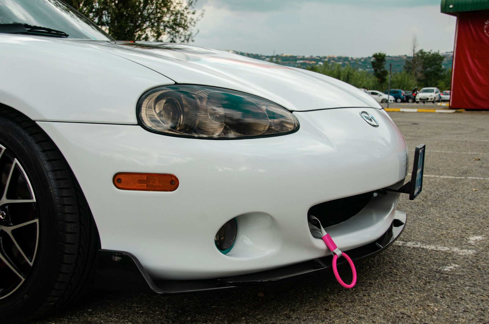 a white sports car parked in a parking lot
